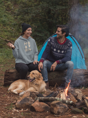 Couple sitting by campfire with dog wearing Heaven pullover hoodie from Mountain Faith Co.
