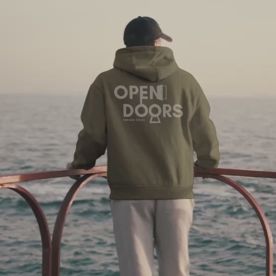 Mountain Faith Co. homepage hero video featuring our Open Doors Hoodie Design at the ocean. 
