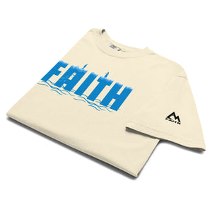 Ivory folded Faith T Shirt with illustration of Peter walking toward Jesus on the water symbolizing trust and surrender by Mountain Faith Co.