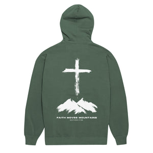 Green Faith Moves Mountains Hoodie with cross standing over rugged mountain peaks inspired by Matthew 17:20 by Mountain Faith Co.
