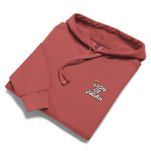 Red folded Mountain Faith Co. Lion of Judah Hoodie with crowned lion graphic and Revelation 5:5 text