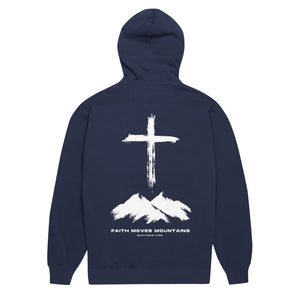Navy blue Faith Moves Mountains Hoodie with cross standing over rugged mountain peaks inspired by Matthew 17:20 by Mountain Faith Co.